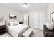 Staged primary bedroom featuring neutral paint and en suite bathroom at 1411 Duhart Ave, Gastonia, NC 28054