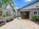 Backyard patio features an outdoor dining area, a wooden fence, and flower accents at 1425 Downs Ave, Charlotte, NC 28205