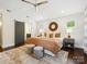 Primary bedroom with ensuite bathroom, stylish decor, ceiling fan, and lots of light at 1425 Downs Ave, Charlotte, NC 28205