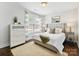Cozy bedroom features a plush rug, neutral decor, and natural light from a window at 1425 Downs Ave, Charlotte, NC 28205