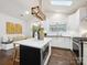 Well-lit kitchen with an island with seating, stainless steel appliances, and a breakfast nook at 1425 Downs Ave, Charlotte, NC 28205