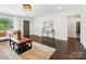 Spacious living room featuring hardwood floors, modern furniture, and large windows at 1425 Downs Ave, Charlotte, NC 28205