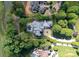 Stunning aerial view of estate home and pool showcasing manicured landscaping, circular drive, and neighborhood at 143 Jeremy Point Pl, Mooresville, NC 28117
