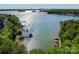 Stunning aerial view of lakefront property featuring private docks, lush trees and sparkling water at 143 Jeremy Point Pl, Mooresville, NC 28117