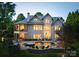 Twilight view of the backyard featuring a pool, hot tub, covered porch, and multi-level patio at 143 Jeremy Point Pl, Mooresville, NC 28117