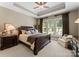 This primary bedroom is complete with a tray ceiling, neutral decor, and large windows at 143 Jeremy Point Pl, Mooresville, NC 28117
