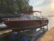 Beautiful wooden boat on lift on a sunny day on the lake, ready for summer fun and water adventures at 143 Jeremy Point Pl, Mooresville, NC 28117