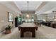 Spacious game room features a pool table, large windows, recessed lighting, and a stone fireplace at 143 Jeremy Point Pl, Mooresville, NC 28117