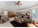 Open-concept living space with a large sectional sofa, bar area and dining space at 143 Jeremy Point Pl, Mooresville, NC 28117