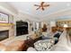 Beautiful living room with comfortable seating, stone fireplace, and large TV at 143 Jeremy Point Pl, Mooresville, NC 28117