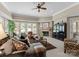Inviting living room featuring a cozy stone fireplace, neutral colors, and large windows at 143 Jeremy Point Pl, Mooresville, NC 28117