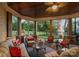 Covered outdoor living area with fireplace, comfortable seating, and scenic views at 143 Jeremy Point Pl, Mooresville, NC 28117