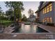Amazing backyard swimming pool with jacuzzi, patio, and beautiful sunset view of the luxurious home at 143 Jeremy Point Pl, Mooresville, NC 28117