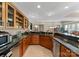 Updated wet bar with granite counters, stainless steel appliances, and wooden cabinetry at 143 Jeremy Point Pl, Mooresville, NC 28117