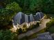 Expansive home with a gray roof, lush landscaping, and a long driveway, captured from an aerial perspective at 15038 Jockeys Ridge Dr, Charlotte, NC 28277