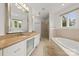 Bright bathroom with a soaking tub, glass shower, and granite countertops at 15038 Jockeys Ridge Dr, Charlotte, NC 28277