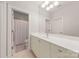 Bathroom featuring a large mirror, patterned wallpaper, and a shower with curtain at 15038 Jockeys Ridge Dr, Charlotte, NC 28277