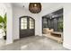 Modern entryway featuring a stylish light fixture, concrete floors, and an arched glass door leading to a living room at 15038 Jockeys Ridge Dr, Charlotte, NC 28277