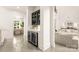 Hallway area with a wet bar featuring wine storage and access to dining and living areas at 15038 Jockeys Ridge Dr, Charlotte, NC 28277