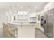Bright kitchen with white cabinetry, large island with seating, and stainless steel appliances at 15038 Jockeys Ridge Dr, Charlotte, NC 28277
