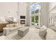 Bright and airy living room with a fireplace, high ceilings, floor-to-ceiling windows, and elegant decor at 15038 Jockeys Ridge Dr, Charlotte, NC 28277