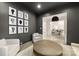 Contemporary living room with dark gray walls, plush seating, geometric rug, modern art, and stylish lighting at 15038 Jockeys Ridge Dr, Charlotte, NC 28277