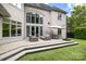 Elegant patio with seating area, dining set, and lush backyard at 15038 Jockeys Ridge Dr, Charlotte, NC 28277