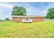 Spacious backyard featuring a well-maintained lawn, mature trees, and a rear deck for outdoor enjoyment at 1690 Montevista Dr, Shelby, NC 28150