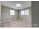 This bedroom provides a well-lit private area that contains two large windows and gray flooring at 1690 Montevista Dr, Shelby, NC 28150