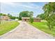 Charming brick home with a long driveway, mature trees, and a well-maintained lawn at 1690 Montevista Dr, Shelby, NC 28150