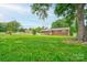 Lovely brick home with a spacious front yard, mature trees, and a welcoming front porch at 1690 Montevista Dr, Shelby, NC 28150