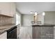 Open kitchen with island, stainless appliances, and sliding glass door to the backyard at 1690 Montevista Dr, Shelby, NC 28150