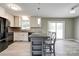 Stylish kitchen featuring a central island, modern lighting, and access to the backyard at 1690 Montevista Dr, Shelby, NC 28150