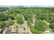 Aerial view of a neighborhood featuring lush greenery, mature trees, and the city skyline in the background at 1701 Dearmon Dr, Charlotte, NC 28205