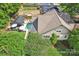 An aerial view of a luxurious backyard with a pool, covered seating area, manicured landscaping and solar panels at 1701 Dearmon Dr, Charlotte, NC 28205