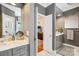 Dual vanity bathroom boasting marble countertops, gray cabinetry, and modern fixtures at 1701 Dearmon Dr, Charlotte, NC 28205