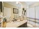 Bathroom with granite countertop, modern fixtures, and decorative accents at 1701 Dearmon Dr, Charlotte, NC 28205