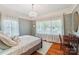 Charming bedroom with a chandelier, hardwood floors, and patterned wallpaper at 1701 Dearmon Dr, Charlotte, NC 28205