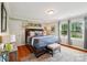Cozy bedroom showcasing hardwood floors, a large bed, and ample natural light through windows at 1701 Dearmon Dr, Charlotte, NC 28205