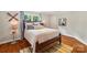 Light and airy bedroom with hardwood floors, a wooden bed frame, and ample natural light at 1701 Dearmon Dr, Charlotte, NC 28205