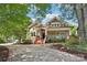 Charming home exterior featuring a covered porch, manicured lawn, and inviting curb appeal at 1701 Dearmon Dr, Charlotte, NC 28205