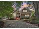 Charming two-story home with a welcoming front porch, lush landscaping, and a well-manicured lawn at 1701 Dearmon Dr, Charlotte, NC 28205