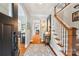 Grand foyer showcases hardwood floors, staircase, and arched entryways, creating an inviting entrance at 1701 Dearmon Dr, Charlotte, NC 28205