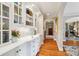 Hallway features hardwood floors, arched doorways, built-in cabinets, and designer touches at 1701 Dearmon Dr, Charlotte, NC 28205
