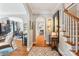 Hallway with hardwood floors and arched doorways leading to the staircase and dining area at 1701 Dearmon Dr, Charlotte, NC 28205