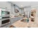 A modern kitchen featuring stainless steel appliances, granite countertops, and custom cabinets at 1701 Dearmon Dr, Charlotte, NC 28205