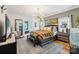 Spacious main bedroom with modern lighting, hardwood floors, and ensuite bathroom at 1701 Dearmon Dr, Charlotte, NC 28205
