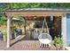 Stylish outdoor bar and lounge area with comfortable seating, a hanging chair and great for entertaining at 1701 Dearmon Dr, Charlotte, NC 28205