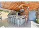 Covered outdoor bar featuring a ceiling fan, TV, and ample seating for a relaxed atmosphere at 1701 Dearmon Dr, Charlotte, NC 28205