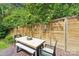 Outdoor dining area features a wood fence backdrop and a stylish table and bench set at 1701 Dearmon Dr, Charlotte, NC 28205
